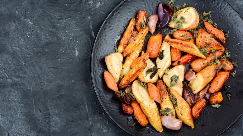 Roasted carrots and parsnips in a black dish