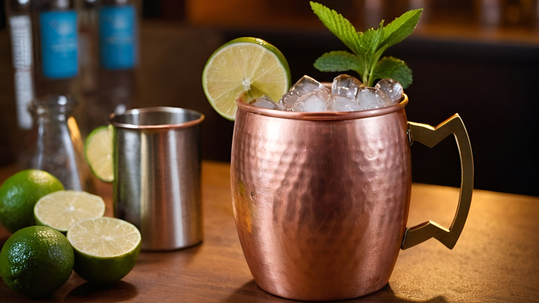 Copper mug surrounded by ingredients used to make a mule cocktail