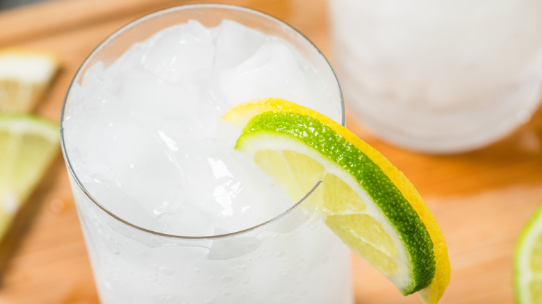 Overhead view of a glass of iced lemon-lime soda with fresh fruit slices
