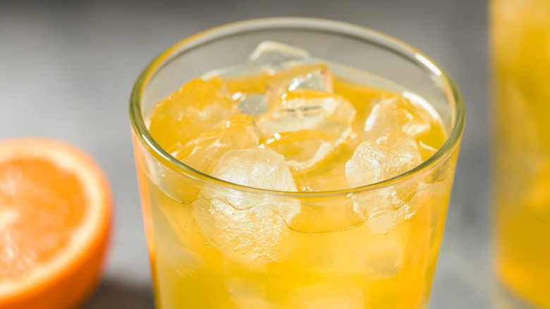 Glass of orange soda on ice