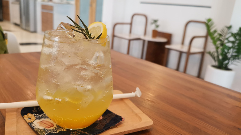 Iced yuzu soda with lemon and rosemary garnish