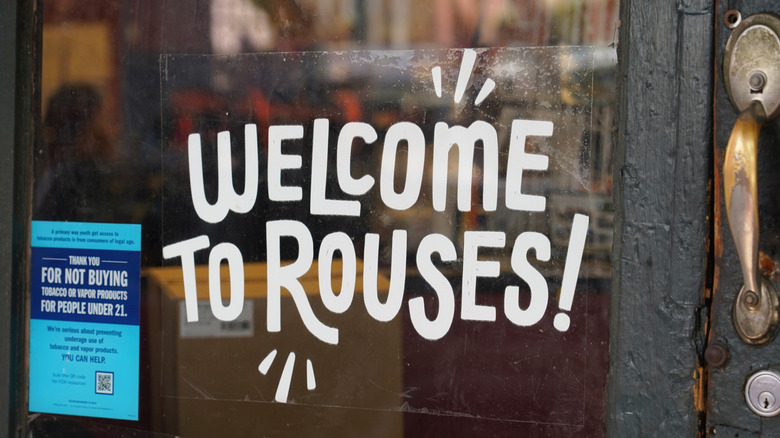 Closeup of a sign welcoming customers to a Rouses grocery store