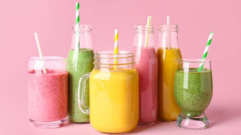 various flavors of smoothies with straws in a glasses