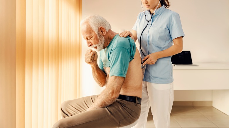 man having breathing checked