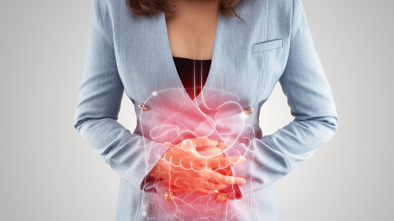 woman holding abdomen in pain