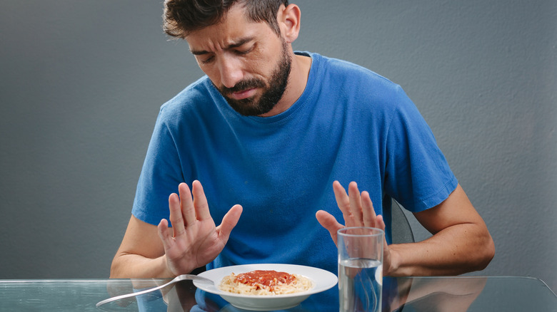 man disgusted with food