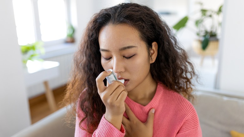 woman using inhaler