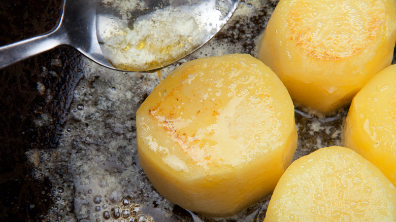 Basting roast potatoes in oil