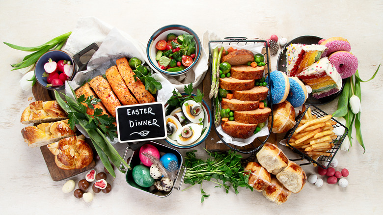A variety of dishes sit against a white background with a small sign reading Easter dinner