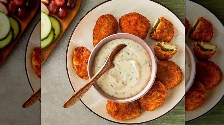A plateof Great Value Cream Cheese Jalapeño Peppers with a bowl of ranch dip.