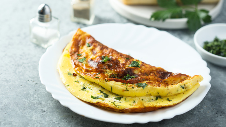 Folded omelet on white plate