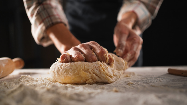 Hands kneading bread dough