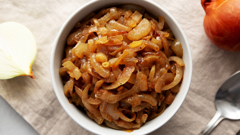 Small white bowl full of caramelized onions