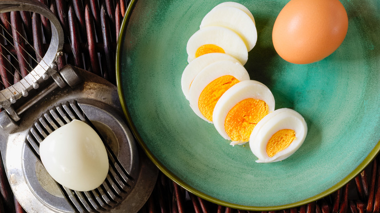 old-fashioned egg slicer with a boiled egg and slices