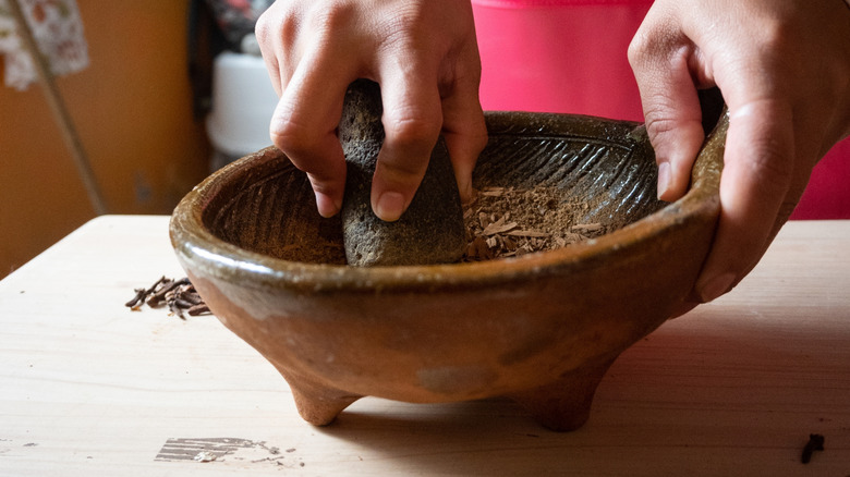 grinding spices in a molcajete