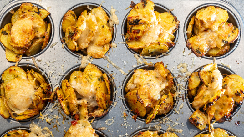 Cheesy scalloped potatoes fill a muffin baking tin