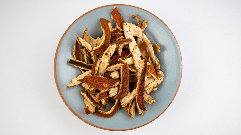 Dried tangerine peel on a white background