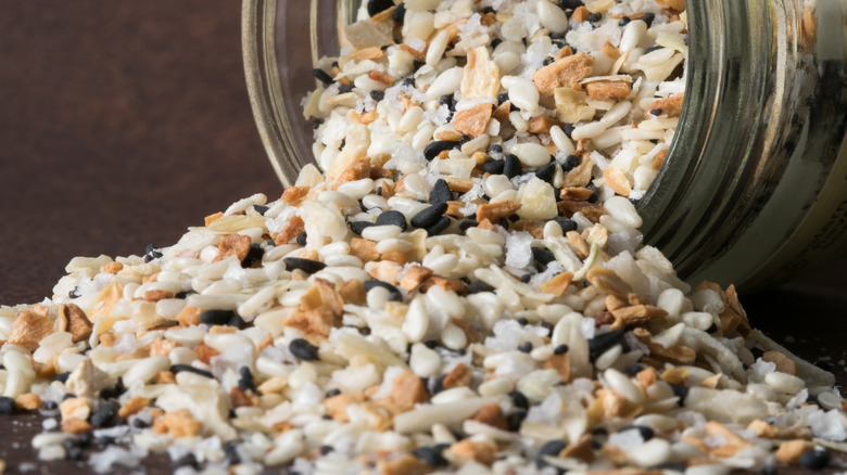 Everything bagel seasoning spilling out of a jar