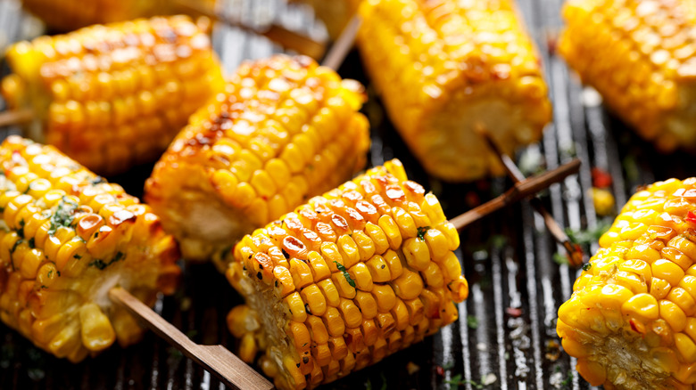 Small corn on the cob pieces cooking on grill