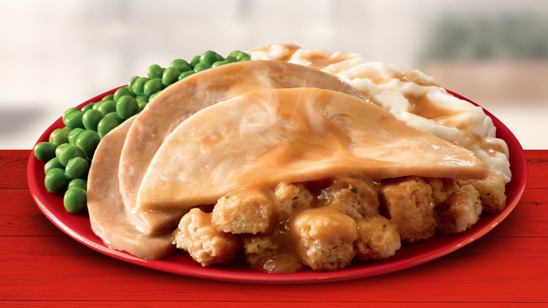 A Banquet Turkey Meal plated on a red dish