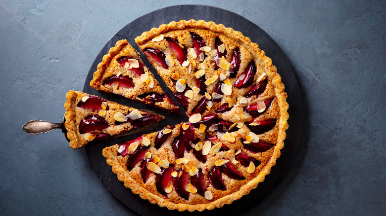Plum pie topped with nuts