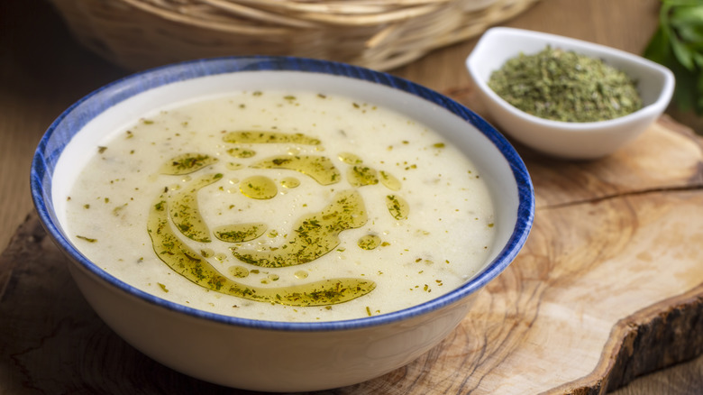 Turkish yogurt soup with a drizzle of oil in a white bowl