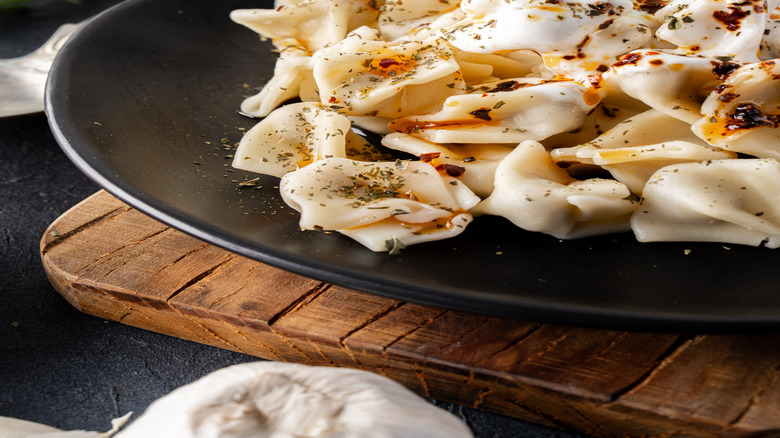 Turkish pasta plated with herbed yogurt sauce