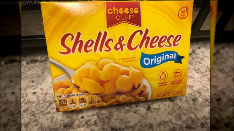 A box Aldi's Shells and Cheese sits on a kitchen countertop