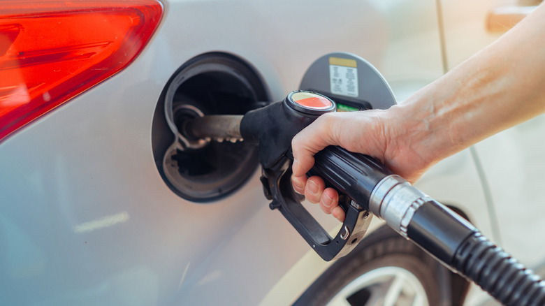 Person pumping gas into their car.