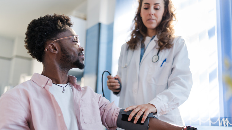 Person getting his blood pressure checked.