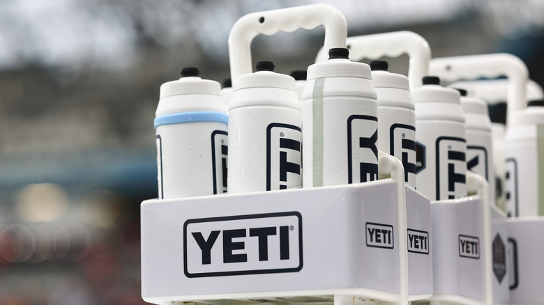 Yeti water bottles in a branded carrier.