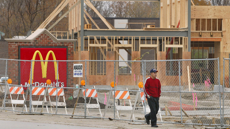 Person walks by a McDonald's under construction