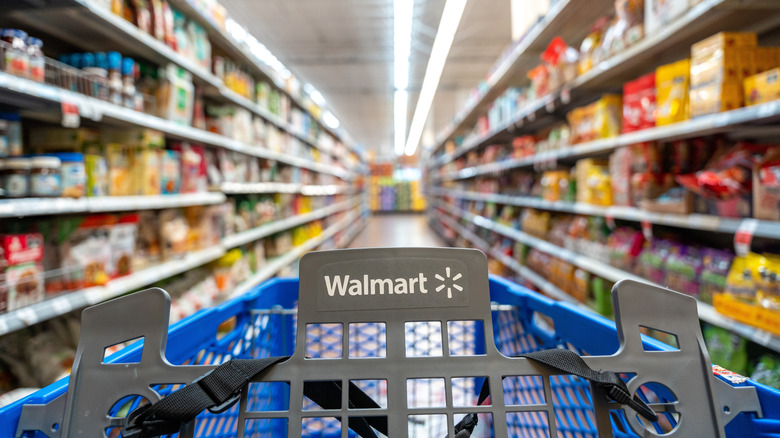 A cart goes down an aisle of a Walmart.