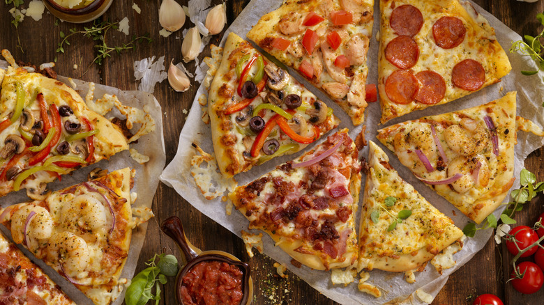 Slices of pizza with various different toppings on each