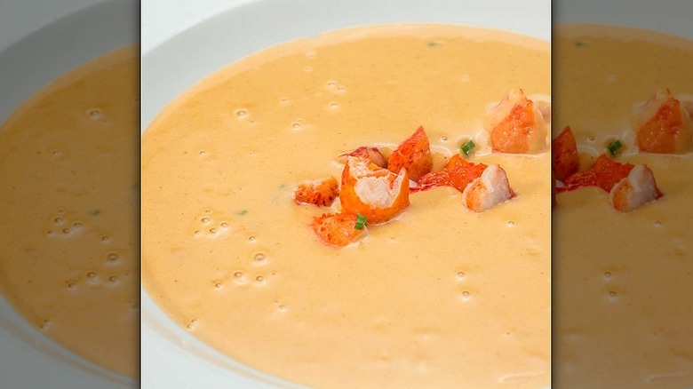Closeup of a bowl of lobster bisque with small lobster pieces at Ocean Prime