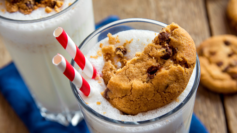 Overhead view of a milkshake with a chocolate chip cookie on top