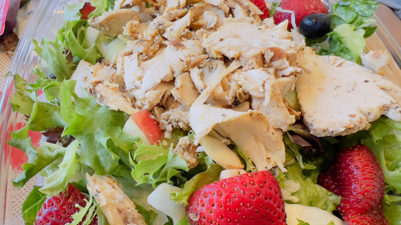 Chick-fil-A salad with chicken, strawberries, and blueberries