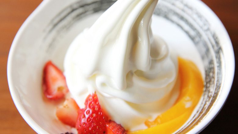 Small dish of soft serve ice cream with fruit