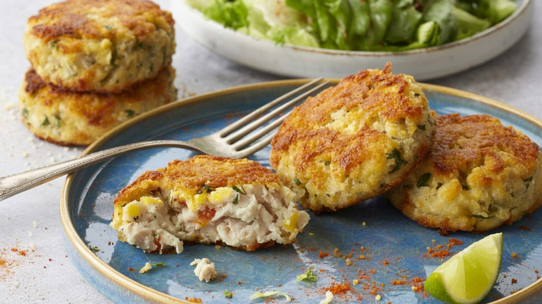 Stack of crab cakes with lemon wedge