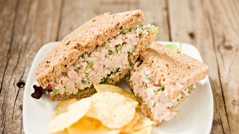 Open face tuna salad sandwich with side of chips