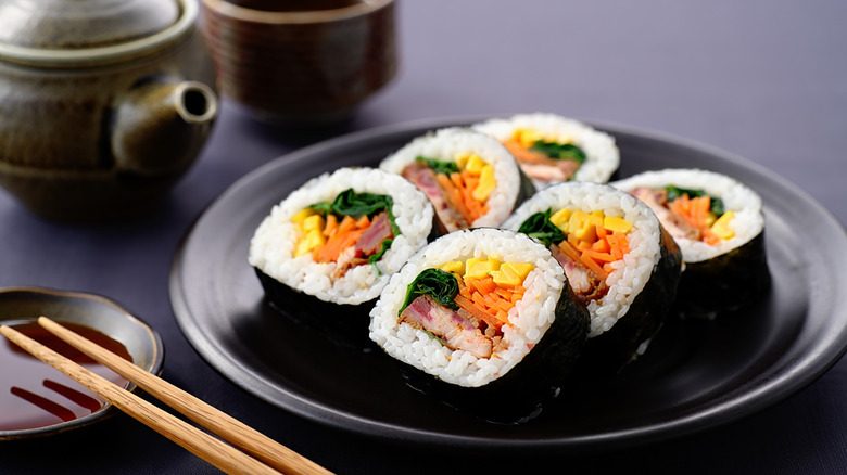 Kimbap served on a plate with chopsticks