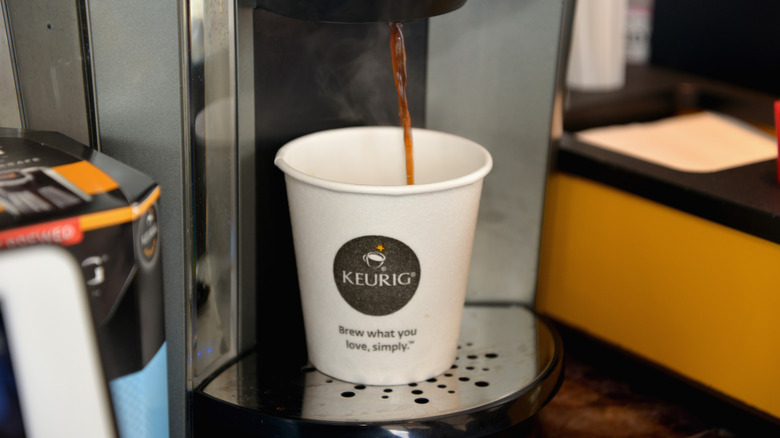 Keurig coffee being brewed into a paper cup