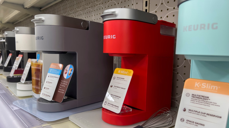 line up of Keurig machines in store of varying colors