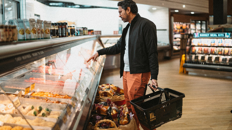 Man orders read-to-eat meal to-go from a deli