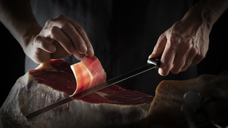 Iberian ham serrano ham getting sliced