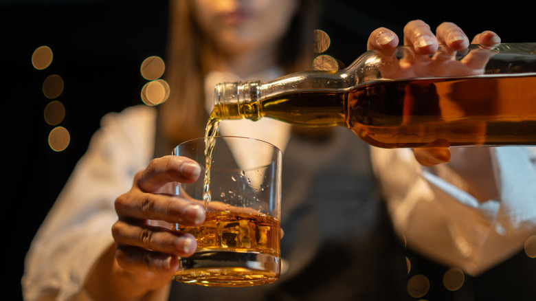 Barman pouring whiskey