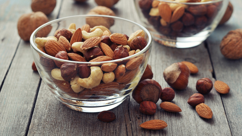 Almonds, walnuts, cashew and hazelnuts in glass bowls
