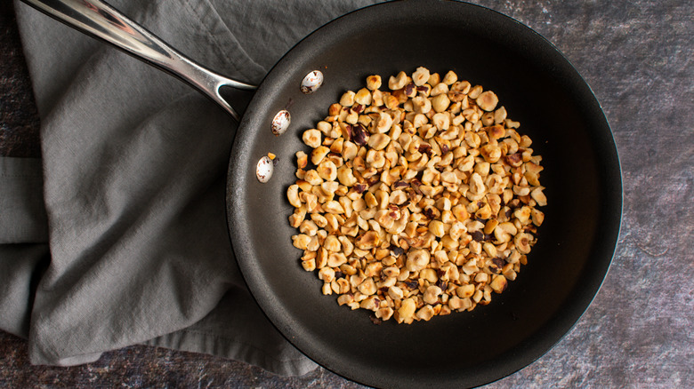 Chopped cobnuts after toasting in a small frypan