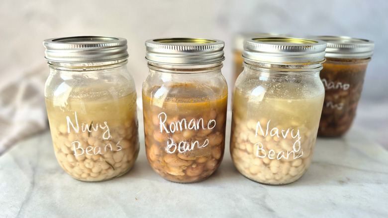 three jars of cooked beans in broth