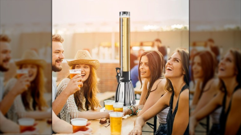 An Oggi beer tower surrounded by a group of friends